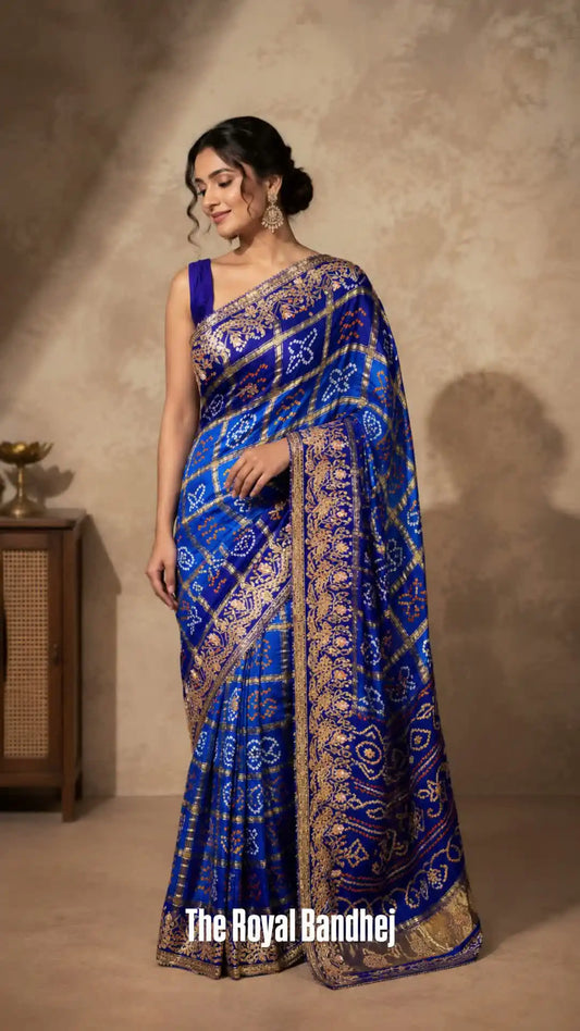 Woman wearing a blue and gold saree with 'The Royal Bandhej' branding.